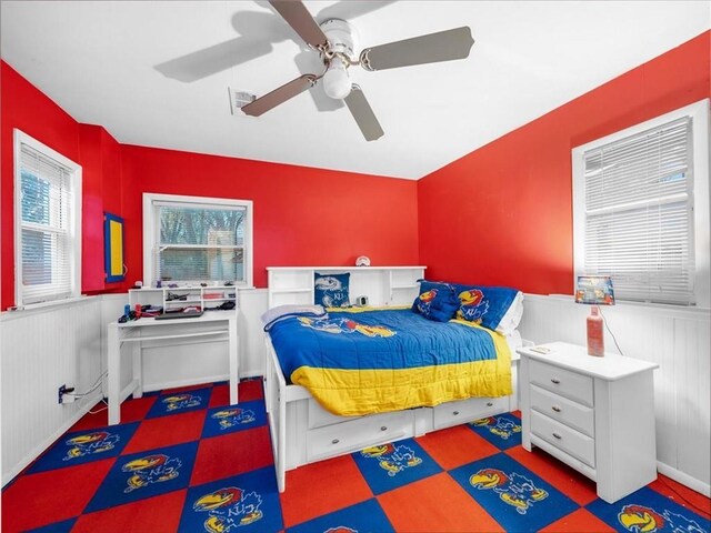 9317 Gillette St, Lenexa, KS 66215 - bedroom with a wainscoted wall and ceiling fan