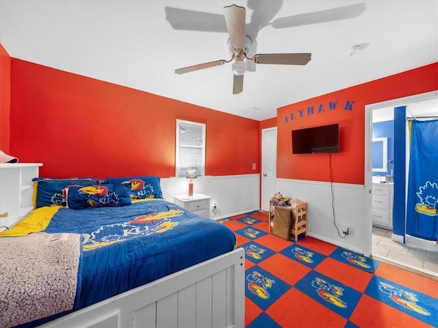 9317 Gillette St, Lenexa, KS 66215 - bedroom featuring a wainscoted wall, a ceiling fan, and ensuite bathroom