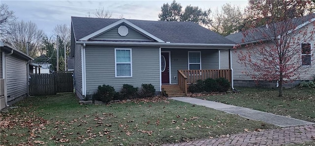 bungalow with a porch and a front yard