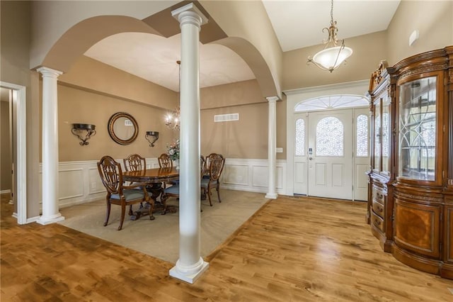 entrance foyer featuring decorative columns and light hardwood / wood-style floors