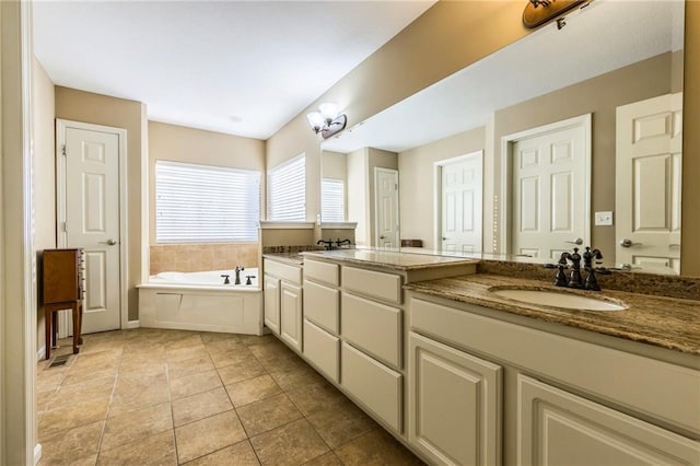 bathroom with vanity, tile patterned floors, and a bathtub