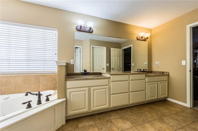 bathroom featuring vanity, tile patterned flooring, and a tub