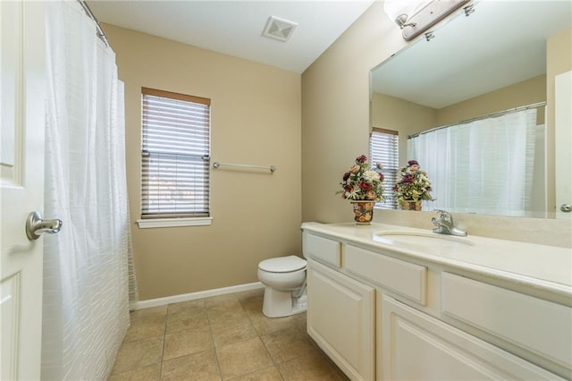 bathroom with vanity, tile patterned floors, and toilet