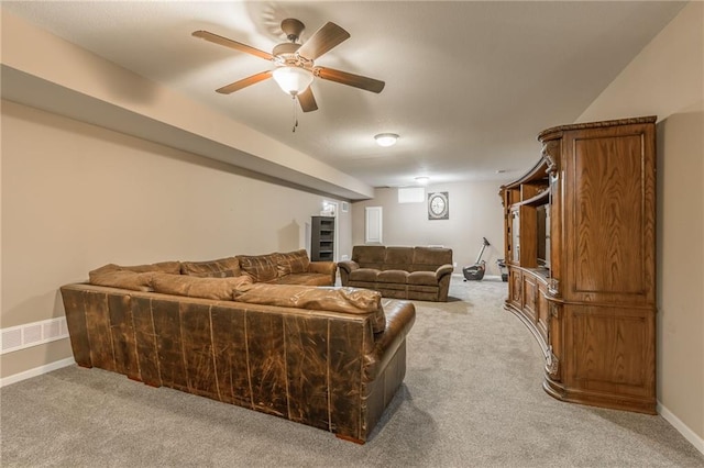 carpeted living room with ceiling fan