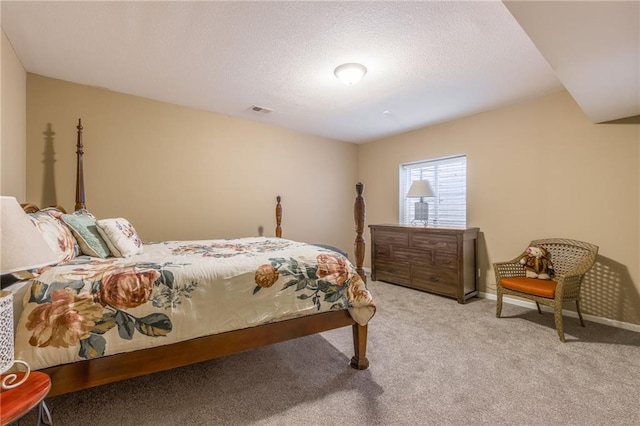 carpeted bedroom with a textured ceiling