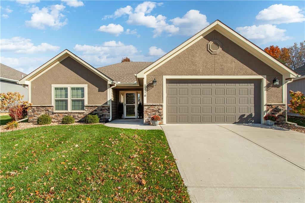 view of front of home with a garage and a front lawn