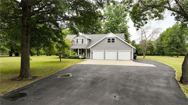 view of front of house with a garage and a front yard