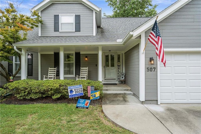 view of front of property featuring covered porch and a garage