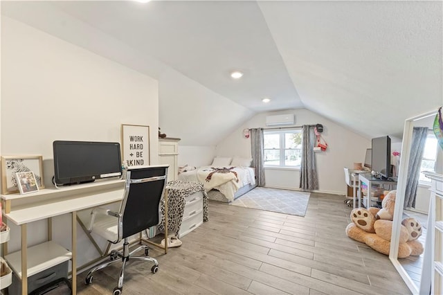 office featuring a wall mounted air conditioner, light wood-type flooring, and lofted ceiling