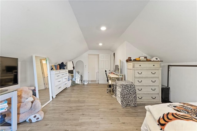 bedroom with light hardwood / wood-style floors and vaulted ceiling