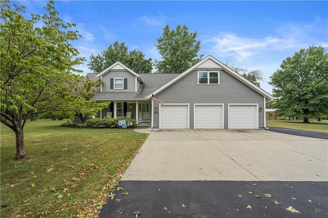 view of front facade featuring a porch, a garage, and a front lawn