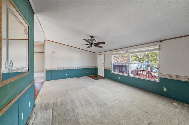 spare room with ceiling fan, crown molding, carpet floors, and a textured ceiling