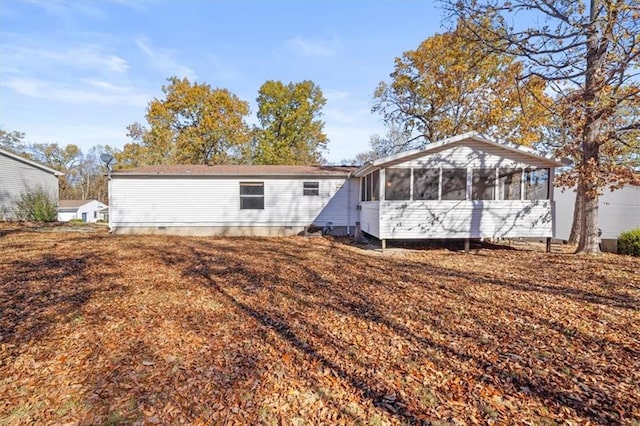 rear view of property with a sunroom