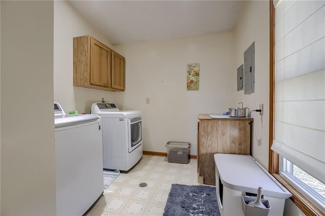 laundry room featuring cabinets, electric panel, and washing machine and clothes dryer