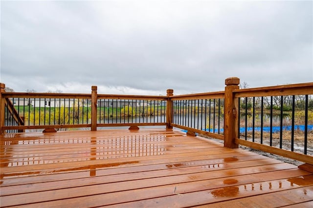 wooden deck featuring a water view