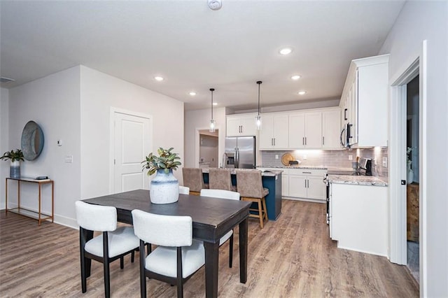 dining area with light hardwood / wood-style flooring