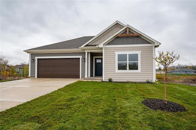 view of front of house featuring a garage and a front lawn