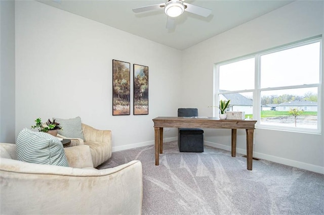 office with a wealth of natural light, light colored carpet, and ceiling fan