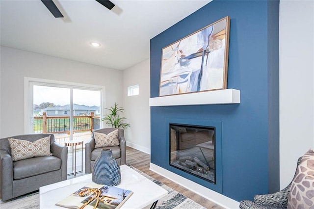 living room with hardwood / wood-style flooring and ceiling fan