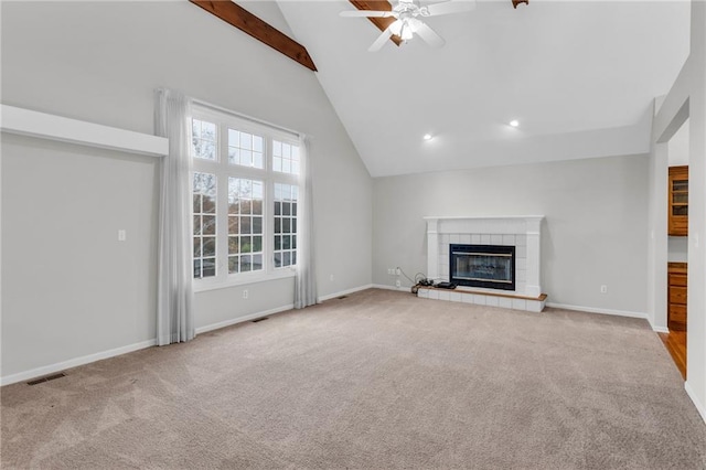 unfurnished living room featuring ceiling fan, light colored carpet, a fireplace, and vaulted ceiling