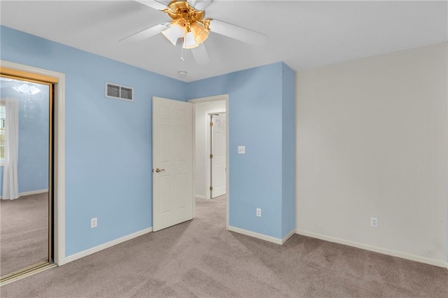 unfurnished bedroom featuring ceiling fan and light carpet