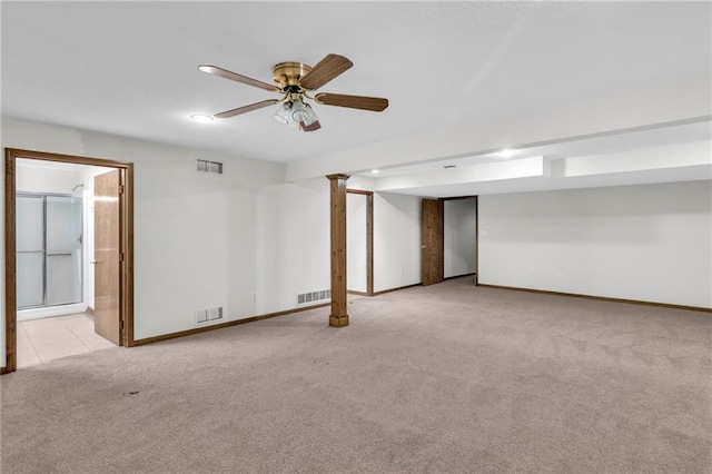 basement featuring ceiling fan and light colored carpet