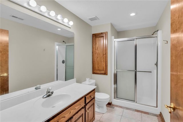 bathroom featuring tile patterned flooring, vanity, an enclosed shower, and toilet