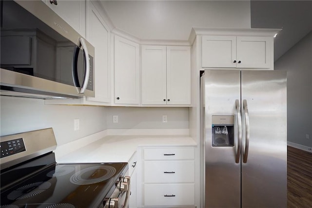 kitchen featuring dark hardwood / wood-style flooring, white cabinetry, and stainless steel appliances