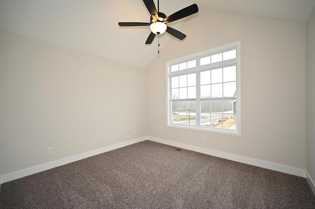 spare room featuring ceiling fan, lofted ceiling, carpet flooring, and a wealth of natural light