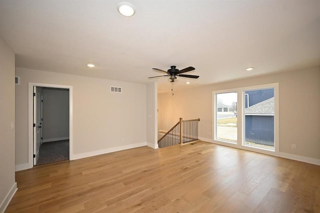 empty room featuring ceiling fan and light wood-type flooring