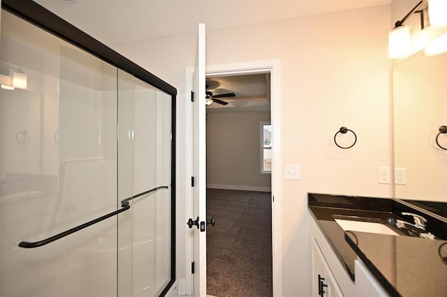 bathroom with ceiling fan, vanity, and an enclosed shower