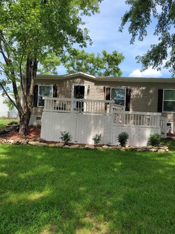 rear view of house with a yard