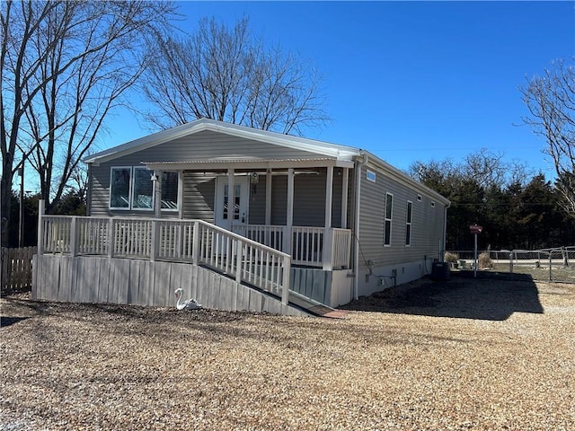 manufactured / mobile home with covered porch and fence