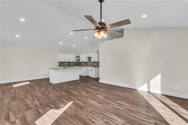 unfurnished living room featuring ceiling fan, lofted ceiling, and wood-type flooring