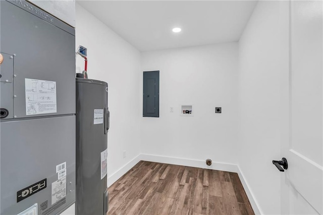 clothes washing area with heating unit, water heater, electric panel, hookup for a washing machine, and hookup for an electric dryer