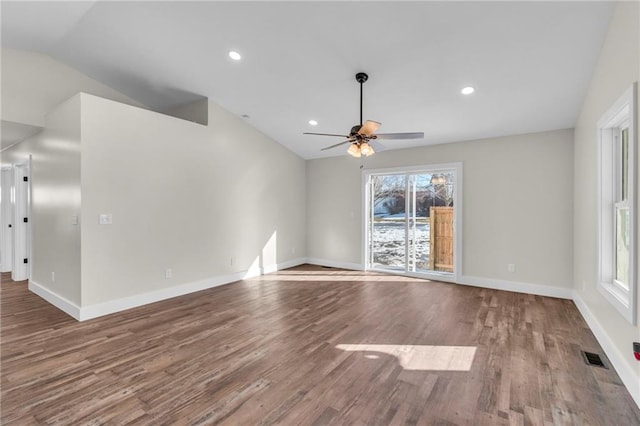 unfurnished room featuring lofted ceiling, hardwood / wood-style flooring, plenty of natural light, and ceiling fan