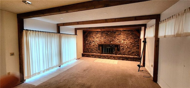 unfurnished living room with beamed ceiling, light colored carpet, a textured ceiling, and a brick fireplace