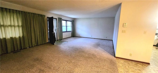 unfurnished room with light carpet