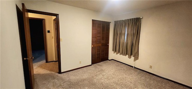 unfurnished bedroom with light colored carpet and a closet