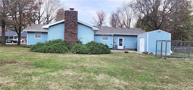 rear view of house featuring a lawn