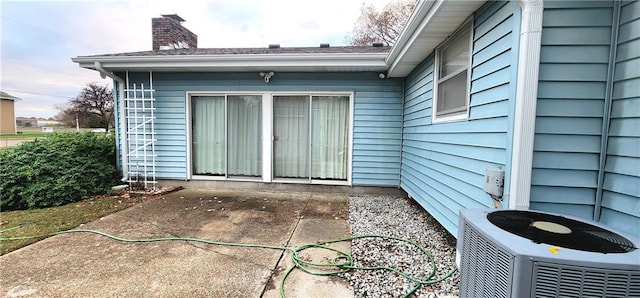 doorway to property featuring a patio area and central air condition unit