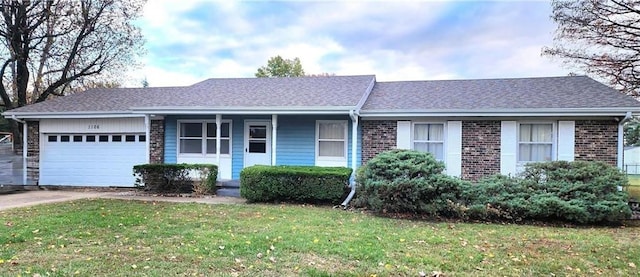 single story home featuring a garage and a front lawn