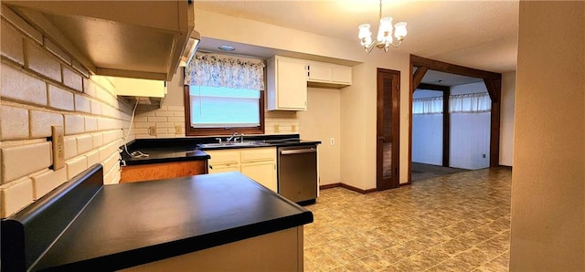 kitchen with stainless steel dishwasher, sink, an inviting chandelier, white cabinetry, and hanging light fixtures