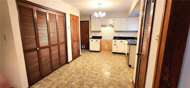 kitchen with backsplash, sink, a notable chandelier, white cabinets, and hanging light fixtures