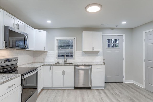 kitchen featuring light hardwood / wood-style floors, white cabinetry, and stainless steel appliances