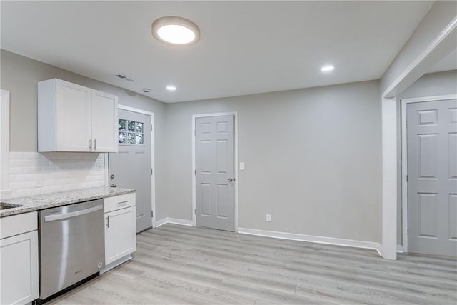 kitchen featuring decorative backsplash, light stone countertops, light wood-type flooring, white cabinets, and dishwasher