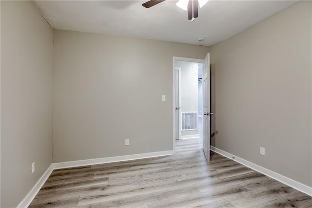 spare room featuring ceiling fan and light wood-type flooring