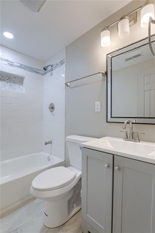 full bathroom featuring vanity, toilet, and tiled shower / bath combo