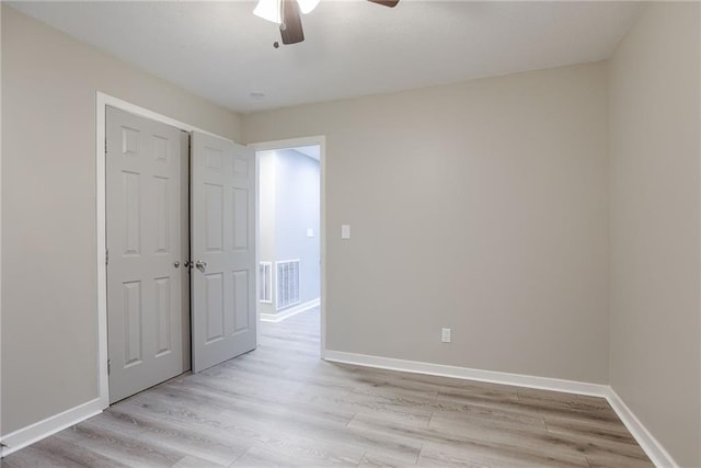 unfurnished bedroom featuring a closet, ceiling fan, and light hardwood / wood-style flooring