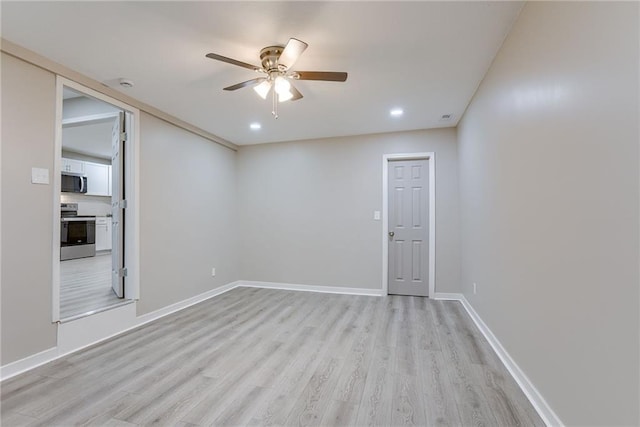 unfurnished room with ceiling fan and light hardwood / wood-style floors